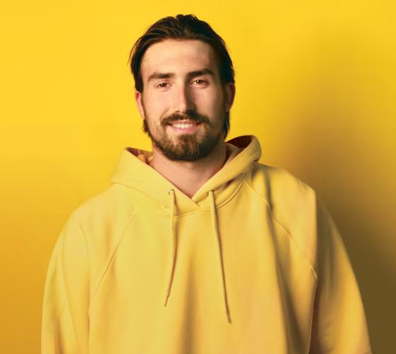 Deep Dive cover image with student in yellow hoodie in front of yellow background