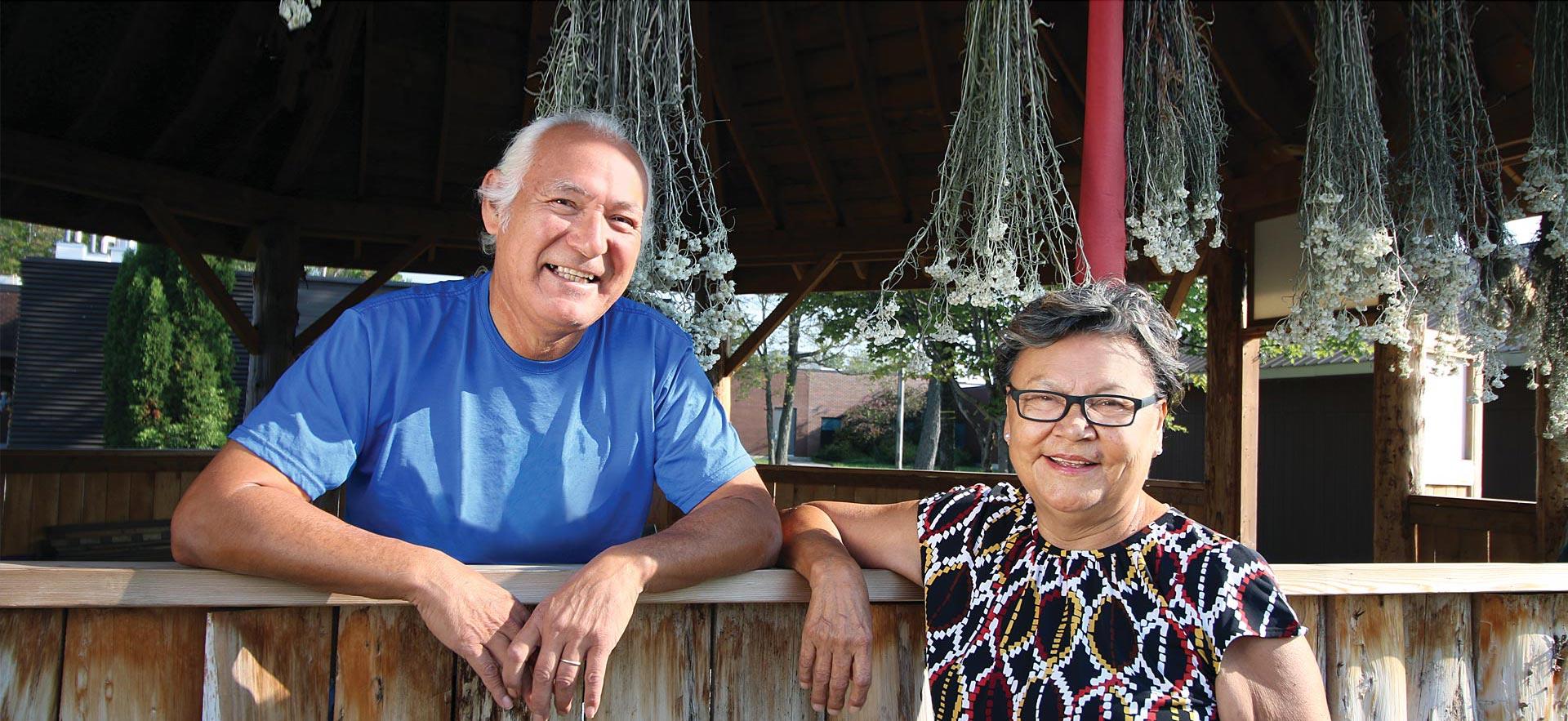 Male and female ӣƵ Indigenous Elders smile for a photo.